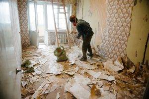 Worker Cleans The Trash In The Apartment In The Bag